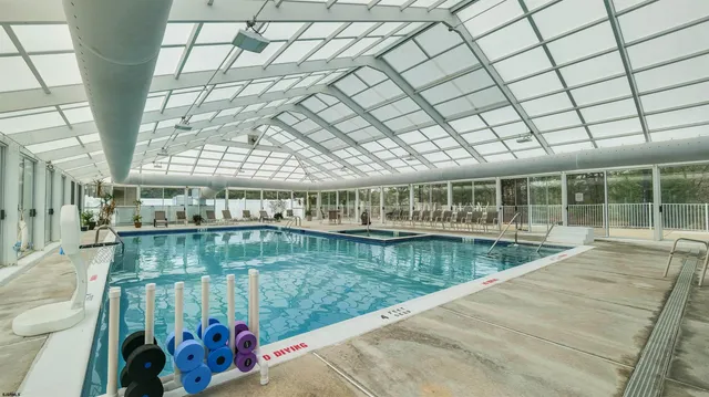 a view of a swimming pool with outdoor seating