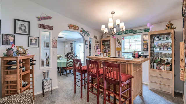 a view of a dining room with furniture and chandelier