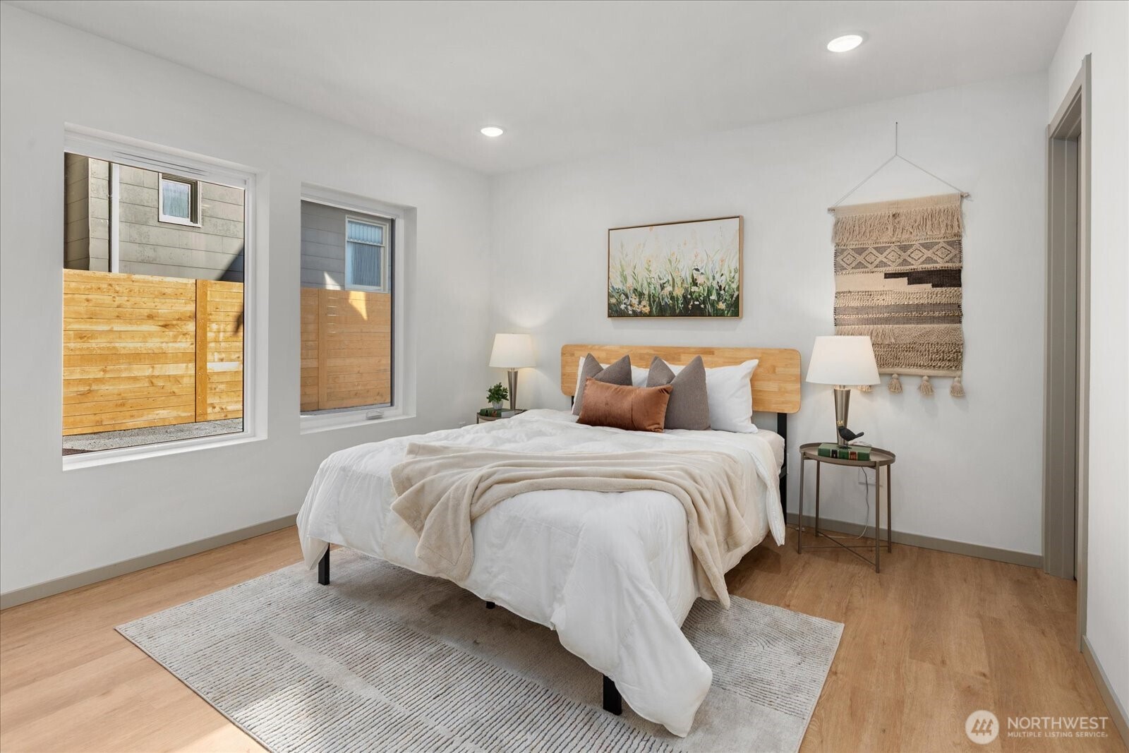 4104 49th Avenue Southwest, Unit B Seattle, WA 98116 - Photo 4 of 17 a bedroom with a bed lamp and a window