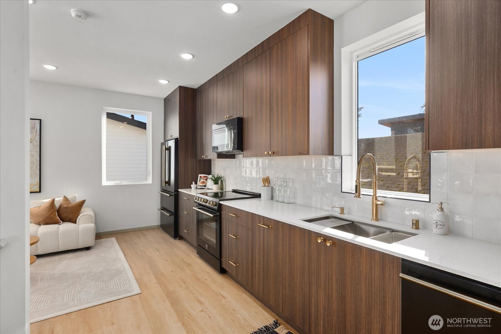 4104 49th Avenue Southwest, Unit B Seattle, WA 98116 - Photo 10 of 17 a kitchen with granite countertop a sink stove and cabinets