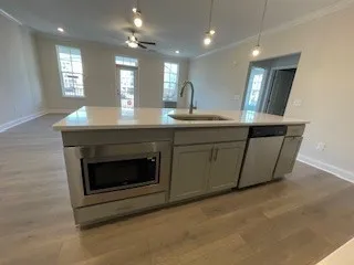 a kitchen with stainless steel appliances granite countertop a stove a sink and a microwave