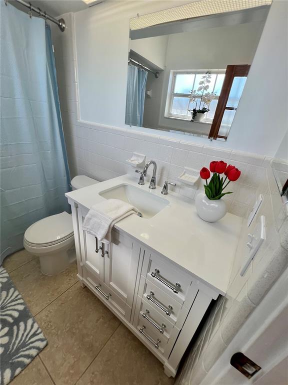 11315 3rd Street East Treasure Island, FL 33706 - Photo 12 of 46 a bathroom with a sink a toilet and mirror