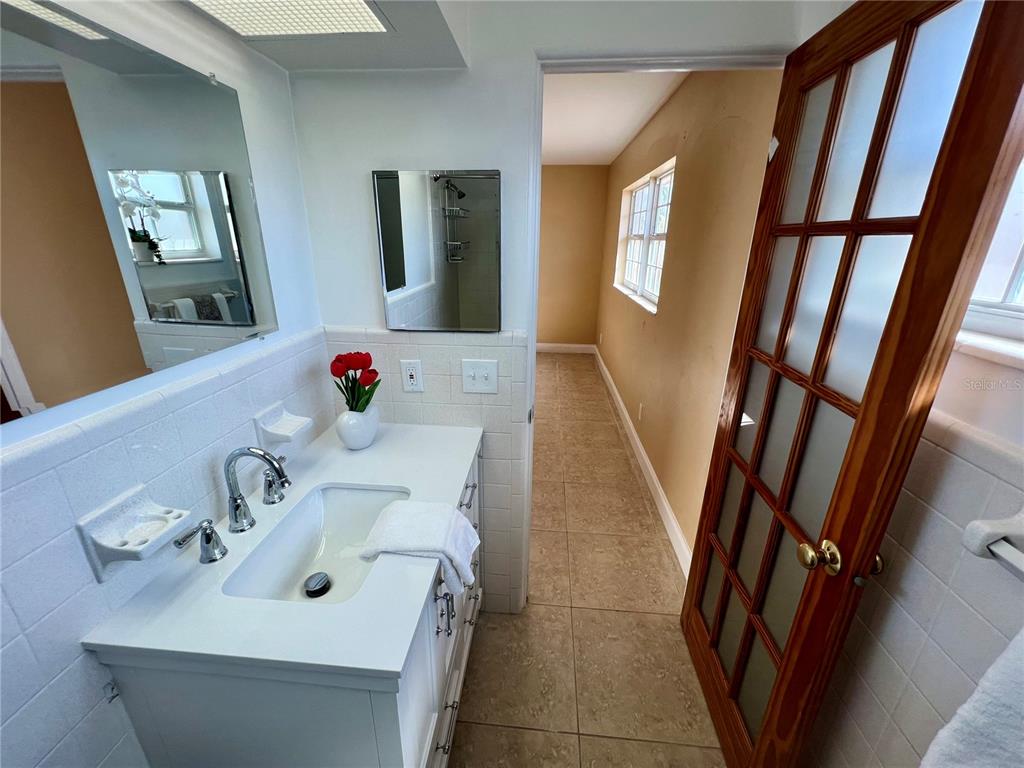 11315 3rd Street East Treasure Island, FL 33706 - Photo 14 of 46 a bathroom with a sink and mirror