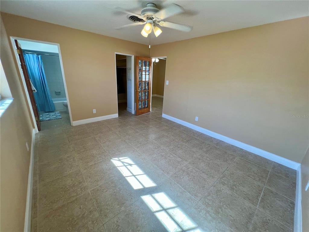11315 3rd Street East Treasure Island, FL 33706 - Photo 16 of 46 an empty room with closet and a chandelier fan