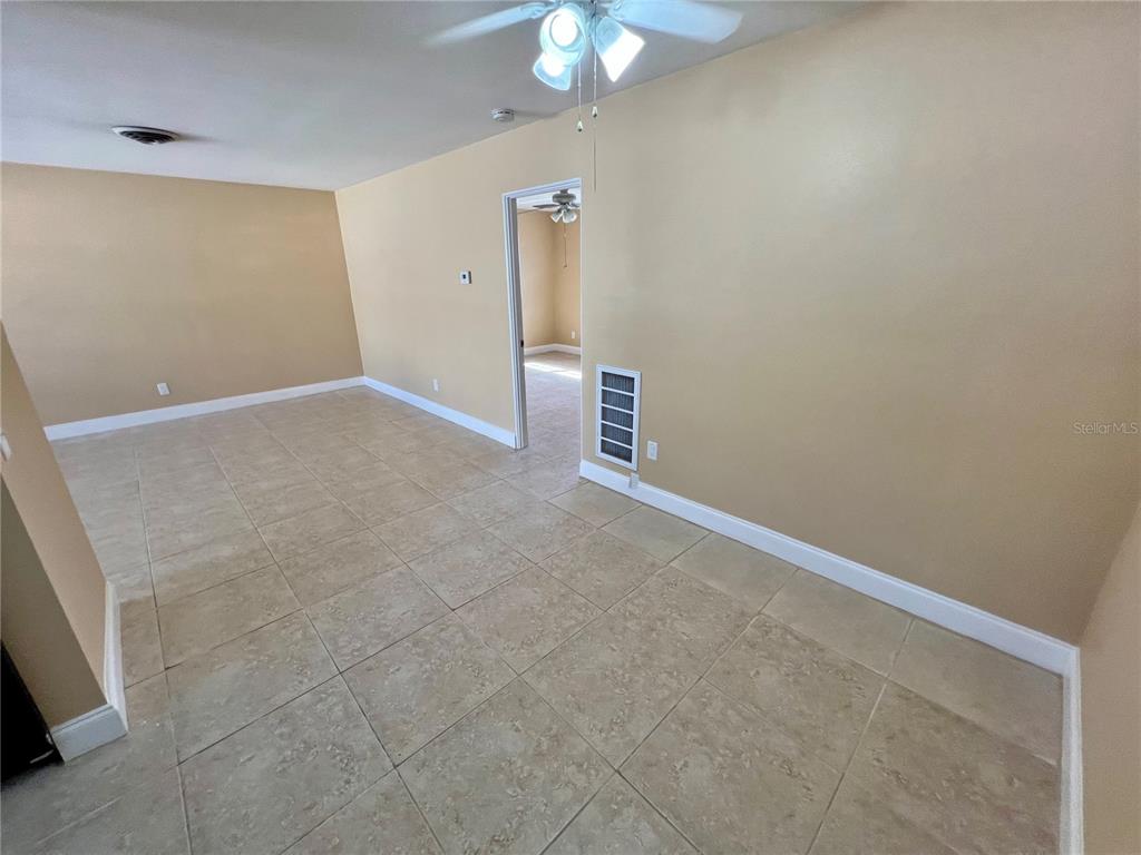 11315 3rd Street East Treasure Island, FL 33706 - Photo 23 of 46 an empty room with a chandelier fan and entryway