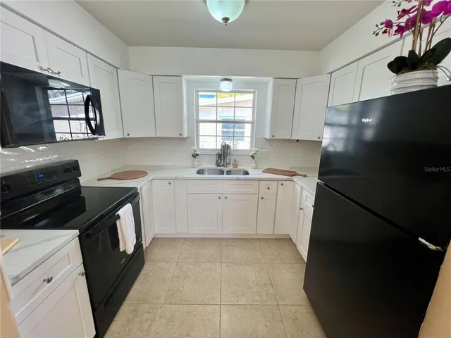 a kitchen with a sink stove and refrigerator