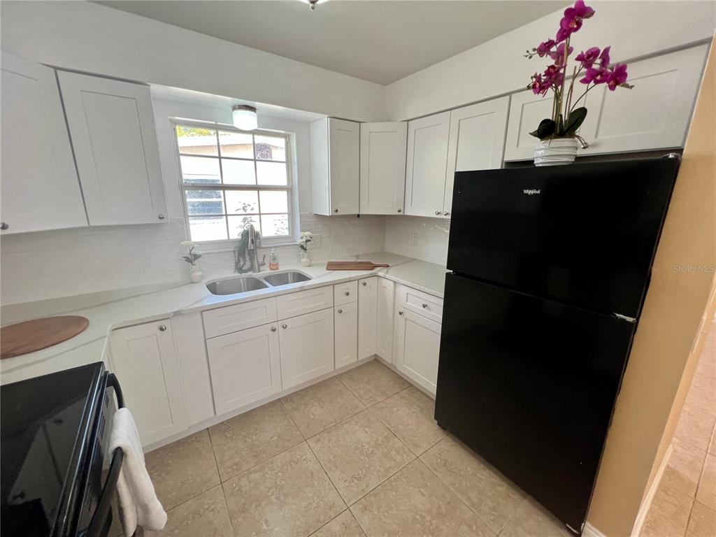 11315 3rd Street East Treasure Island, FL 33706 - Photo 6 of 46 a kitchen with a sink cabinets and window