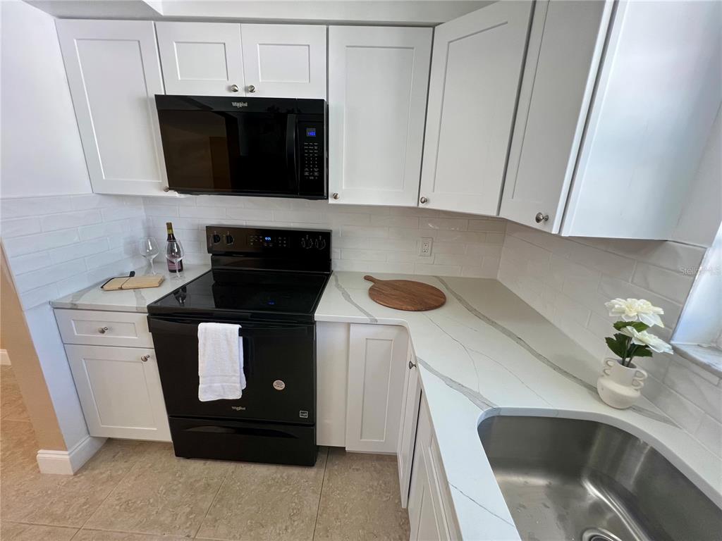 11315 3rd Street East Treasure Island, FL 33706 - Photo 8 of 46 a kitchen with a sink and cabinets