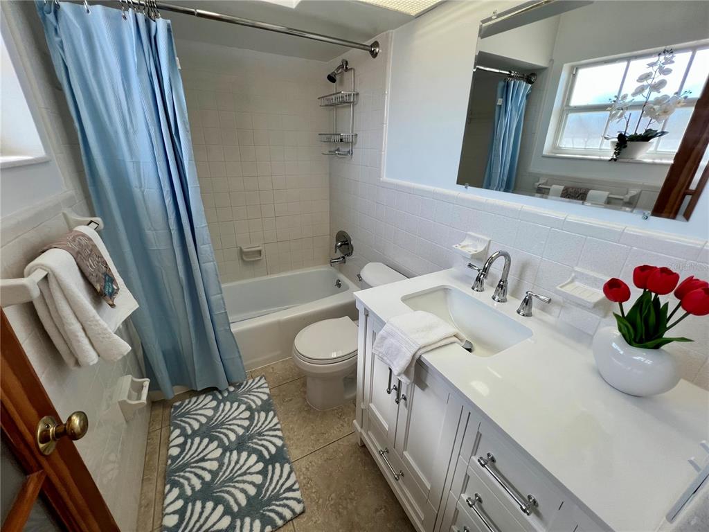 11315 3rd Street East Treasure Island, FL 33706 - Photo 9 of 46 a bathroom with a sink a toilet and shower curtain