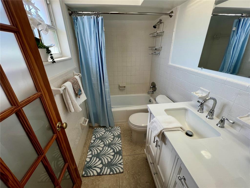 11315 3rd Street East Treasure Island, FL 33706 - Photo 10 of 46 a bathroom with a sink and a mirror