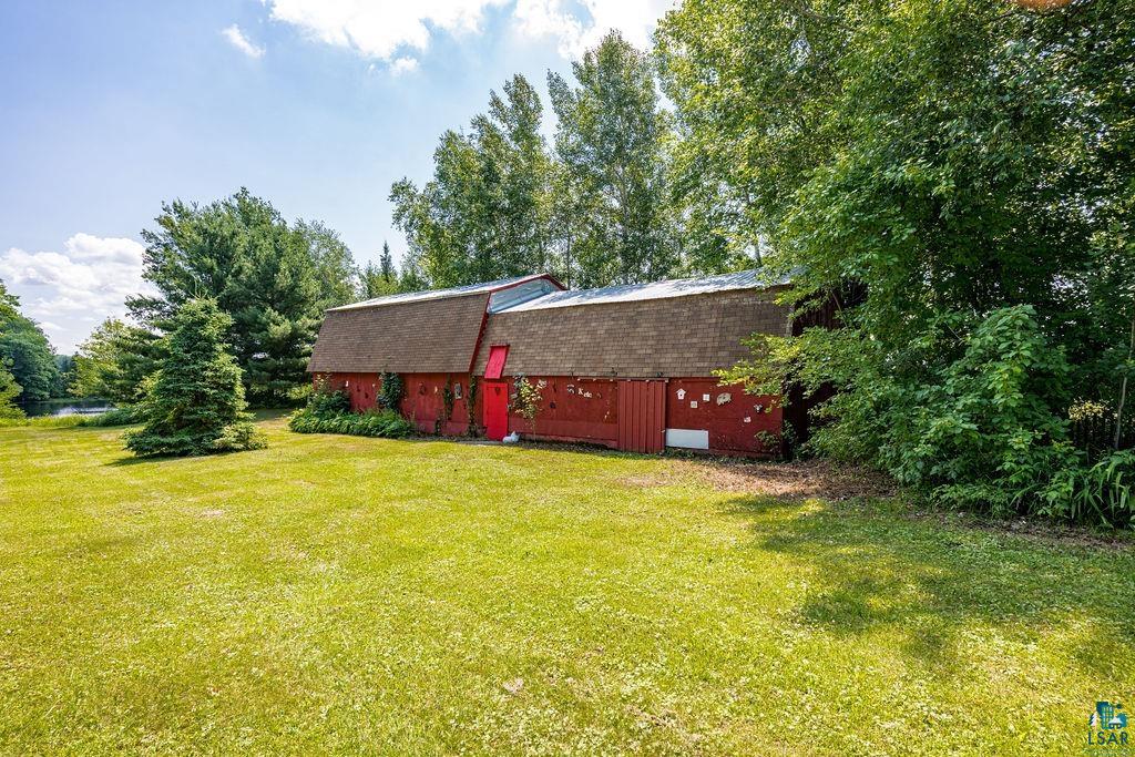 2592 Strandberg Road Barnum, MN 55707 - Photo 23 of 44 Red gambrel-roof barn with a red entry door, a skylight element, and a side access door