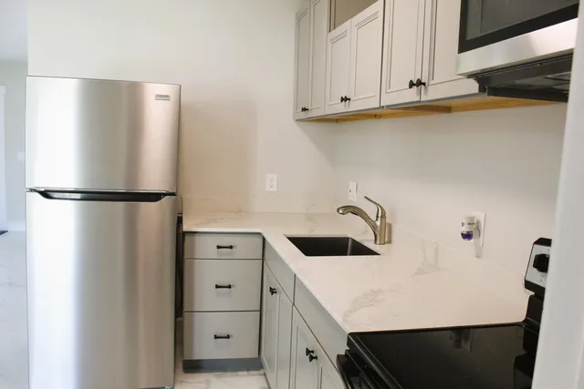 a kitchen with cabinets and stainless steel appliances