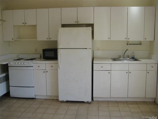 a utility room with cabinets washer and dryer