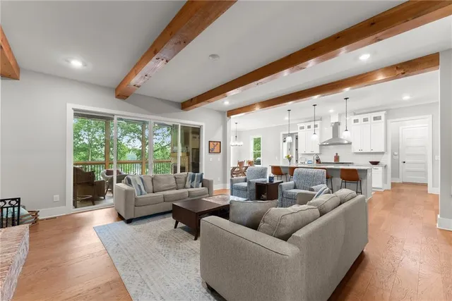 a large kitchen with stainless steel appliances kitchen island granite countertop a stove a sink a dining table and chairs