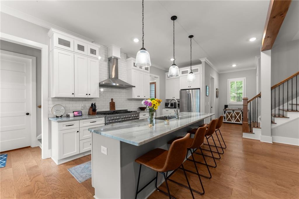 4847 Destitute Way Gainesville, GA 30506 - Photo 14 of 67 a large kitchen with stainless steel appliances kitchen island granite countertop a stove a sink a dining table and chairs