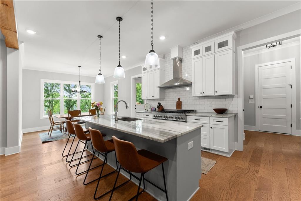 4847 Destitute Way Gainesville, GA 30506 - Photo 15 of 67 a kitchen with stainless steel appliances granite countertop a sink a stove and a wooden floors