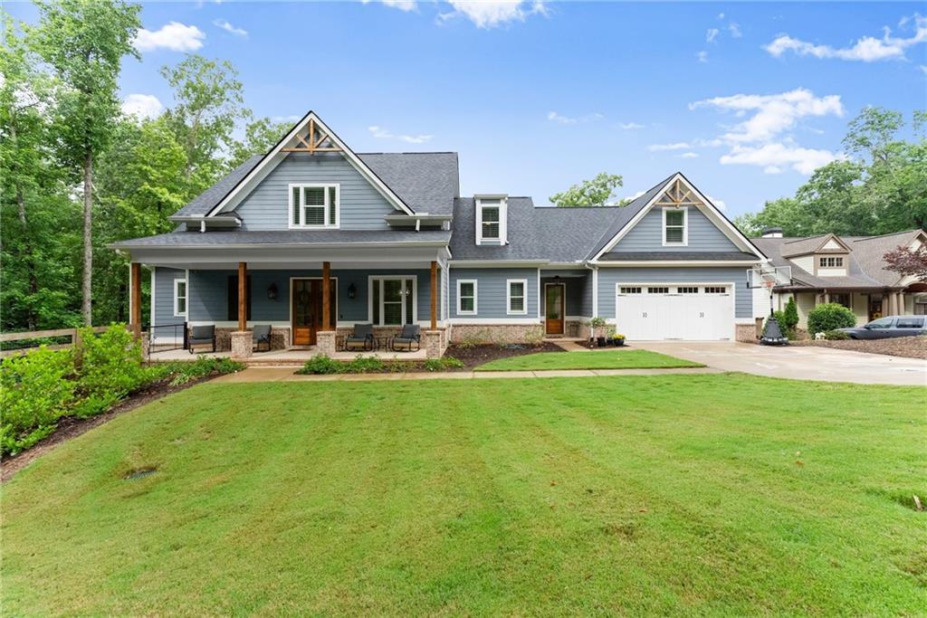 4847 Destitute Way Gainesville, GA 30506 - Photo 2 of 67 a front view of a house with a yard table and chairs