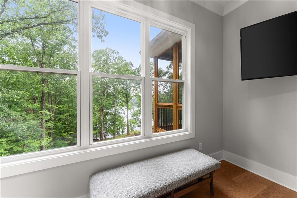 4847 Destitute Way Gainesville, GA 30506 - Photo 27 of 67 a living room with a large window and a flat screen tv