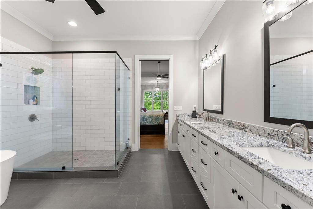 4847 Destitute Way Gainesville, GA 30506 - Photo 31 of 67 a bathroom with a double vanity sink and mirror