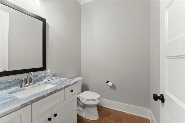 a bathroom with a granite countertop double vanity sink a mirror and a