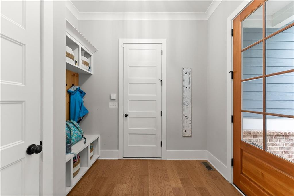4847 Destitute Way Gainesville, GA 30506 - Photo 34 of 67 a view of hallway with walk in closet and wooden floor