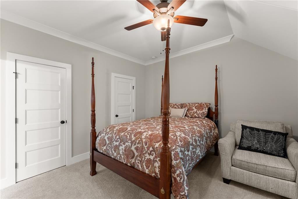 4847 Destitute Way Gainesville, GA 30506 - Photo 40 of 67 a bedroom with a bed and a chandelier