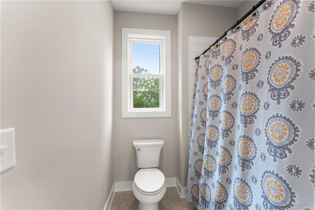 4847 Destitute Way Gainesville, GA 30506 - Photo 43 of 67 a white toilet sitting next to a shower curtain