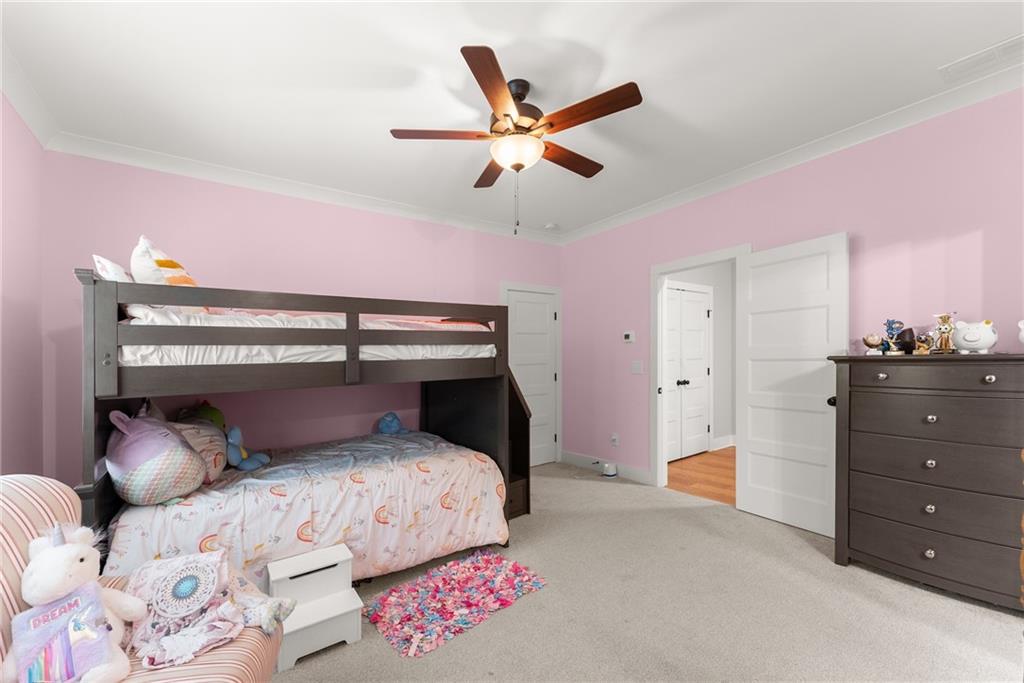 4847 Destitute Way Gainesville, GA 30506 - Photo 48 of 67 a bedroom with a bed and a chandelier