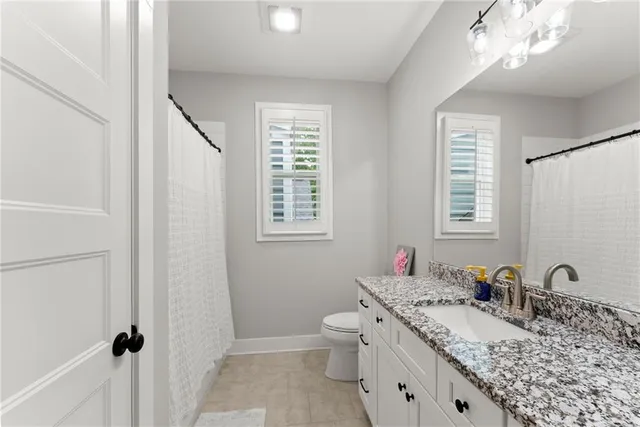 an aerial view of a house with a yard and lake view