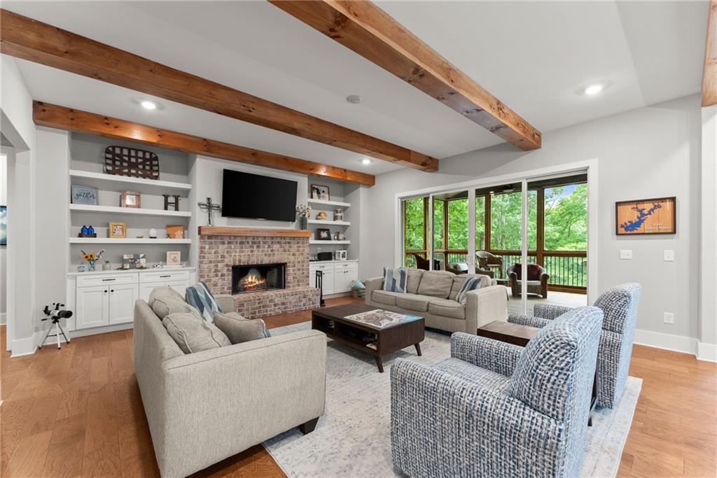 4847 Destitute Way Gainesville, GA 30506 - Photo 9 of 67 a living room with fireplace furniture and a flat screen tv