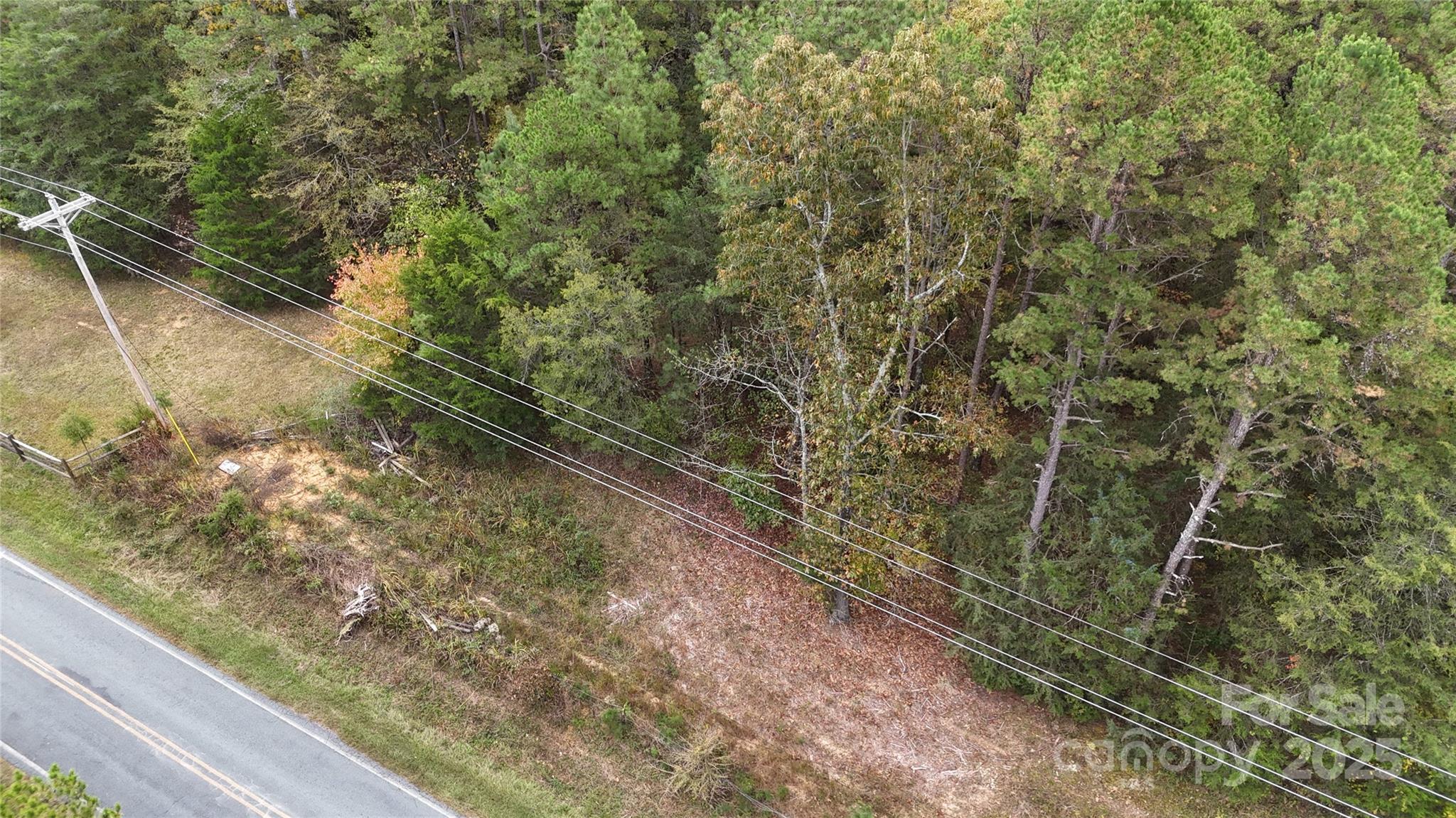 a view of a yard with wooden fence