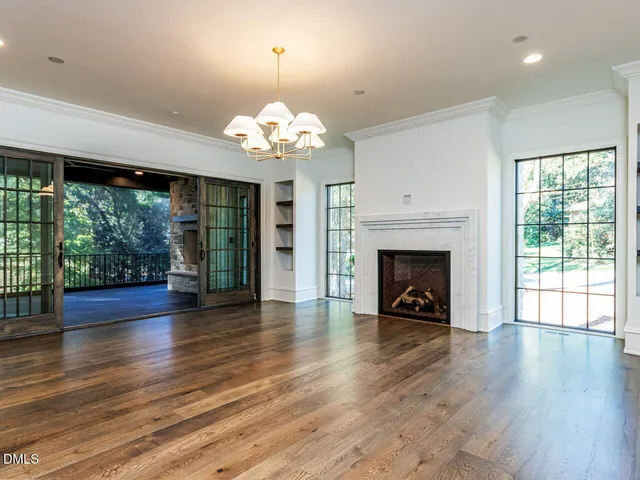 a living room with wooden floors and a fireplace