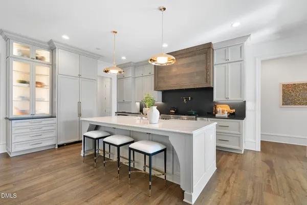 a kitchen with a table chairs refrigerator and cabinets