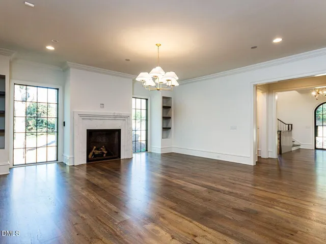 a living room with a fireplace with wooden floor