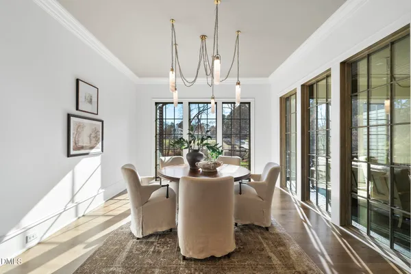 a living room with furniture a fireplace and a chandelier