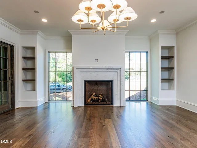 a view of a kitchen with a stove wooden floor and a large window