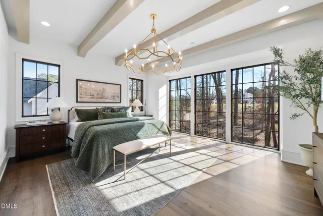 a view of an entryway with wooden floor door and windows