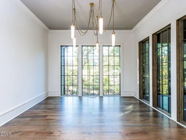 a view of a room with wooden floor and large window