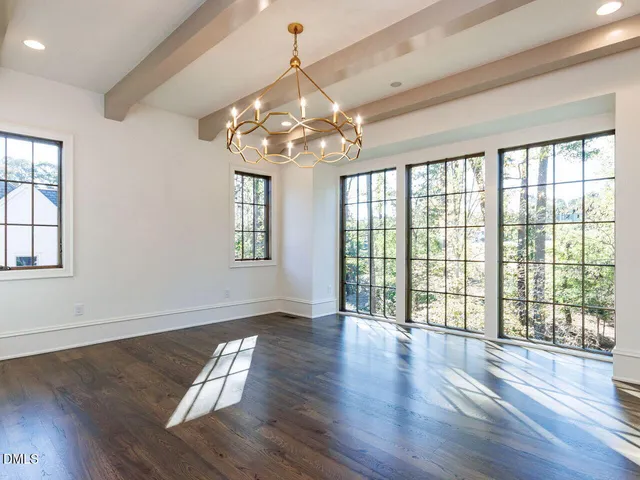 a spacious bathroom with a tub sink and mirror