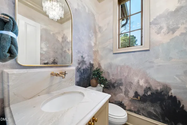 a view of a dining room with furniture and chandelier