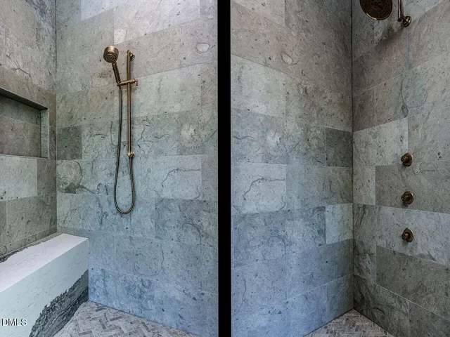 a bathroom with a granite countertop toilet sink and mirror