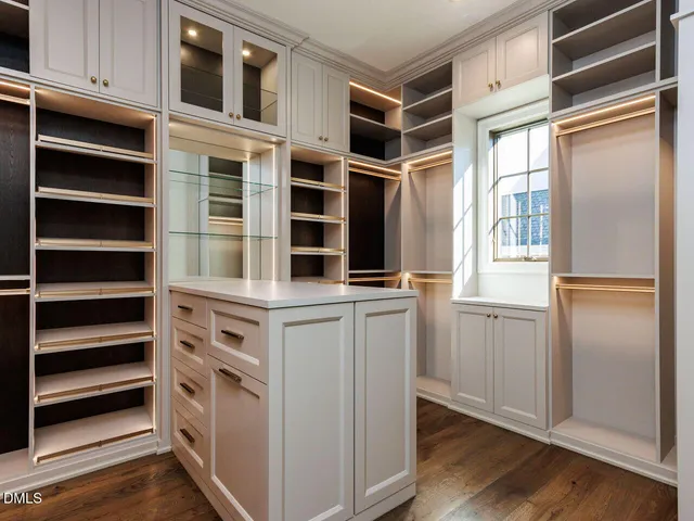 a white bath tub sitting next to a white sink and vanity