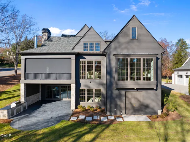 a kitchen with stainless steel appliances granite countertop a sink a stove and white cabinets