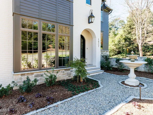 a front view of a house with a garden
