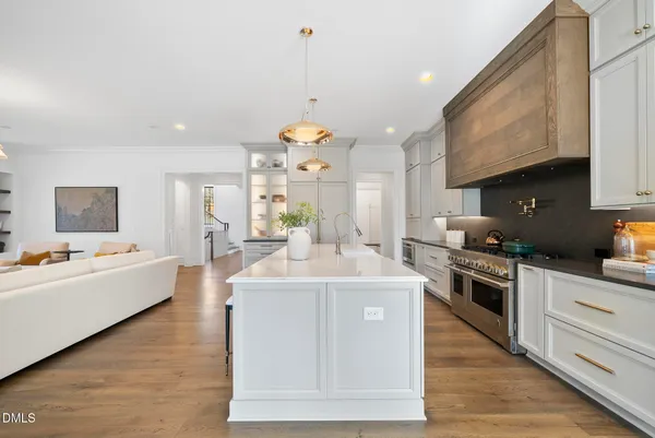 a large kitchen with kitchen island a sink a counter top space and stainless steel appliances