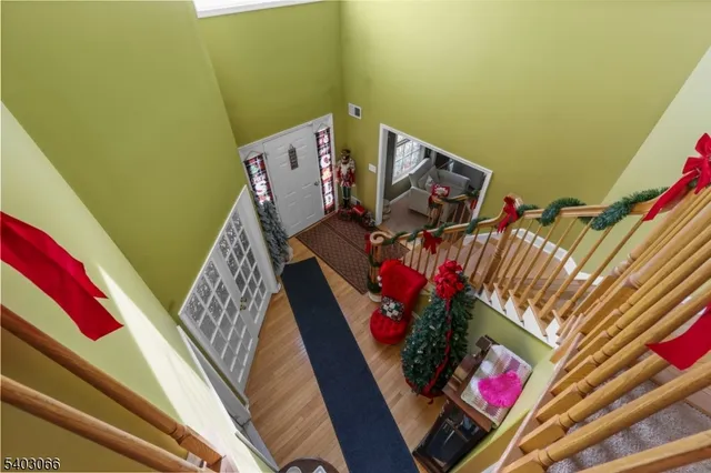 a view of a balcony with wooden floor and a potted plant