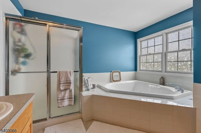 a bathroom with a granite countertop bathtub and a sink