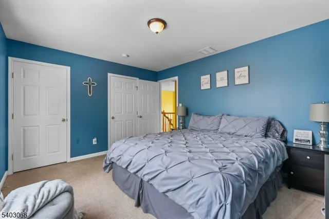 a bedroom with a bed and a lamp