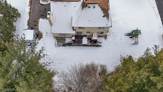 an aerial view of a house with table and chairs
