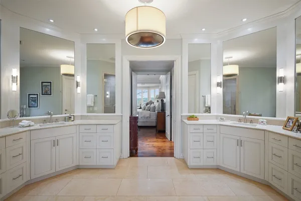 a spacious bathroom with a granite countertop sink a toilet and a mirror